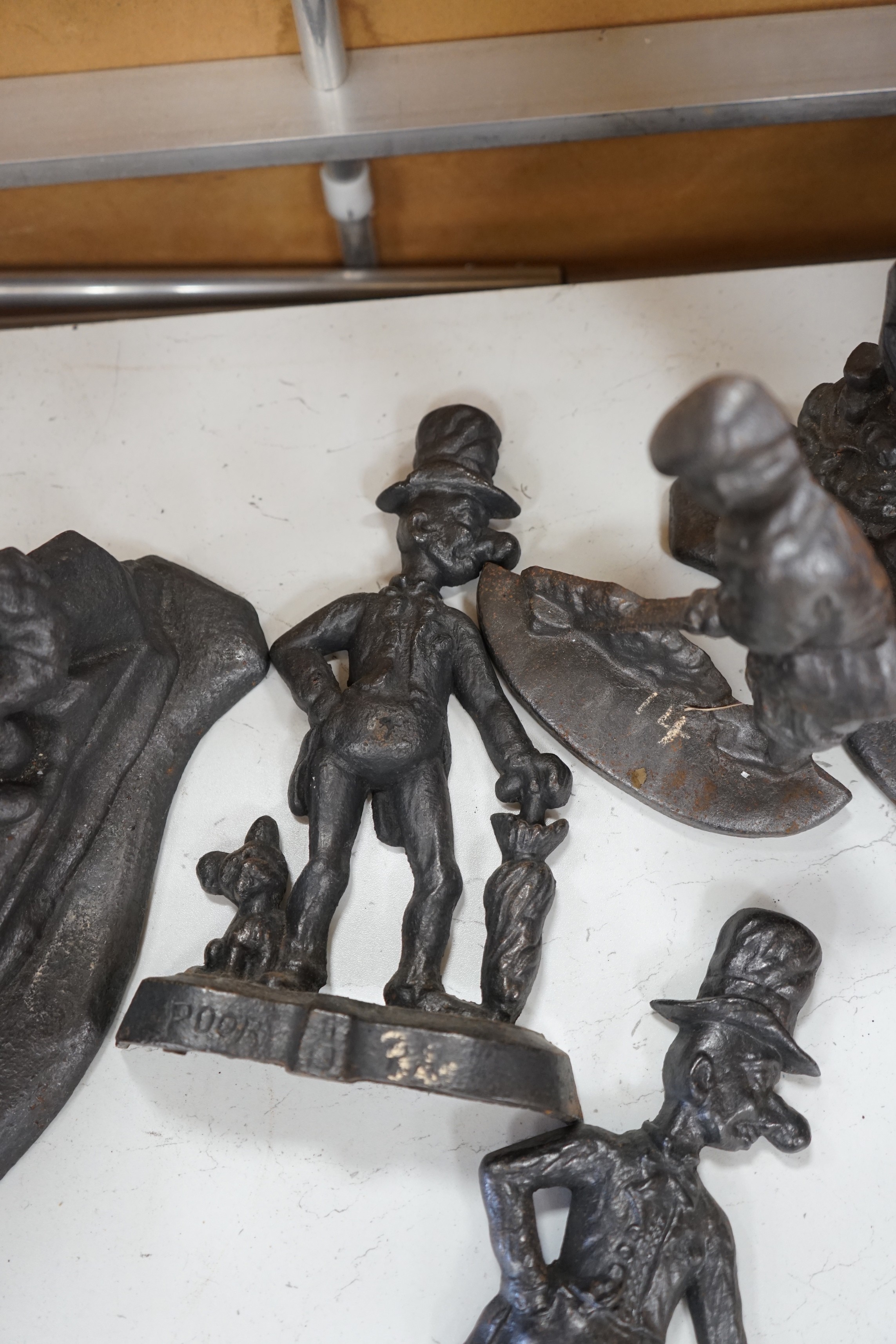 Five assorted Victorian figural cast iron doorstops